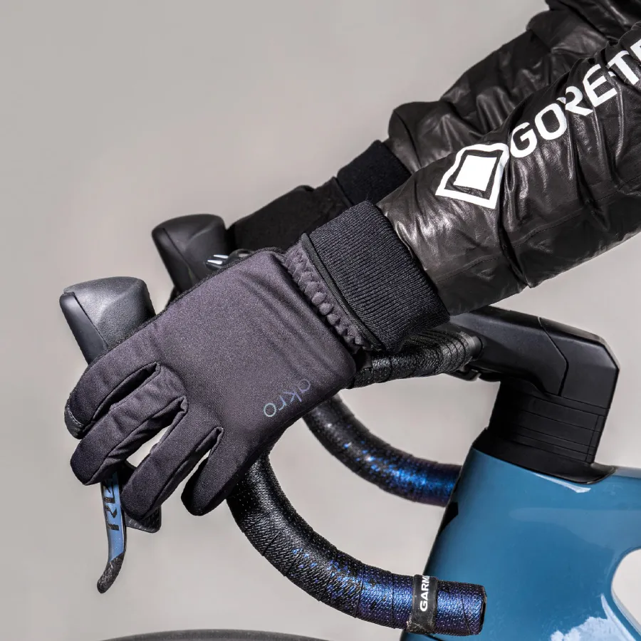 Cyclist wearing Akro gloves holding bike brakes