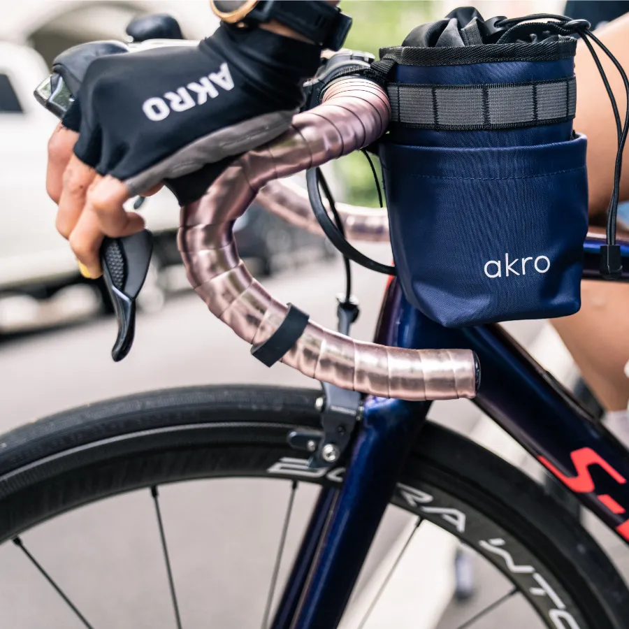 Blue Akro bag on a bicycle ride by cyclist wearing Akro gloves